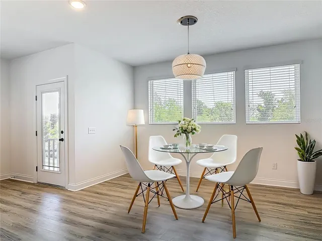 a view of a dining room with furniture wooden floor and chandelier