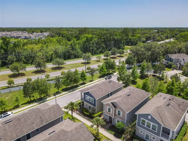 an aerial view of a house with a garden and lake view