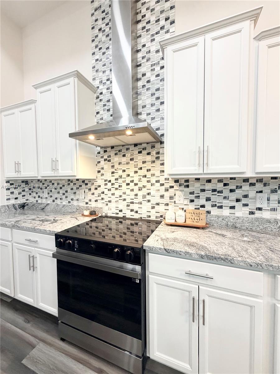 7041 Northeast 22nd Ct Road Ocala, FL 34479 - Photo 31 of 55 a kitchen with granite countertop white cabinets and appliances