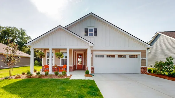 a view of a house with backyard porch and sitting area