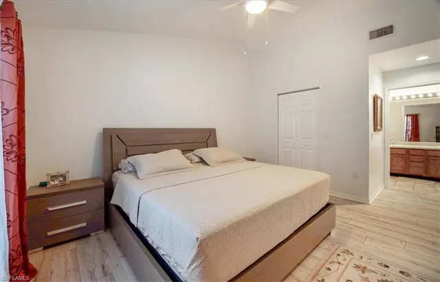 a bedroom with a bed and a book shelf
