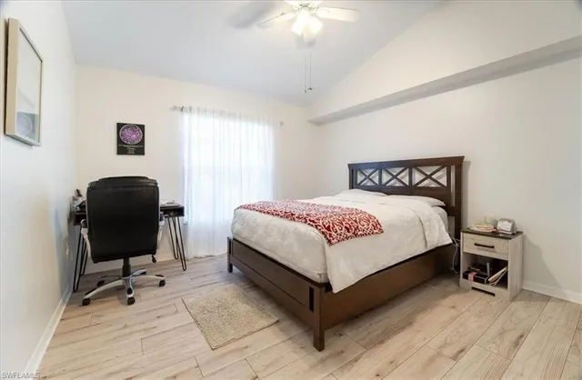 a bedroom with a bed and a chair