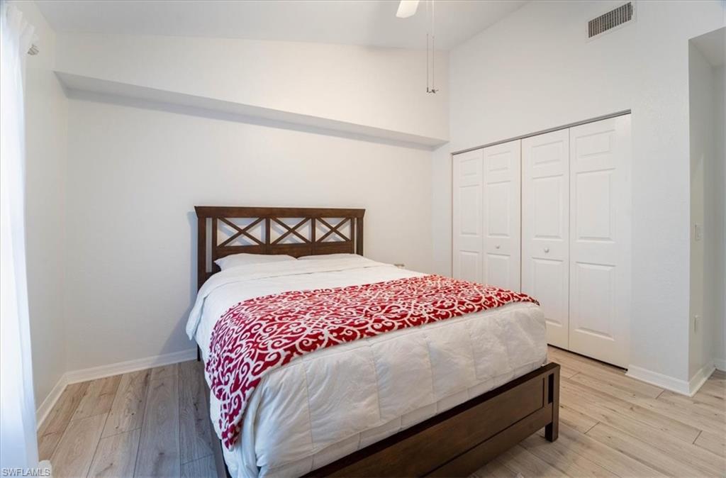 7925 Preserve Circle, Unit 333 Naples, FL 34119 - Photo 15 of 25 a bedroom with a bed and wooden floor