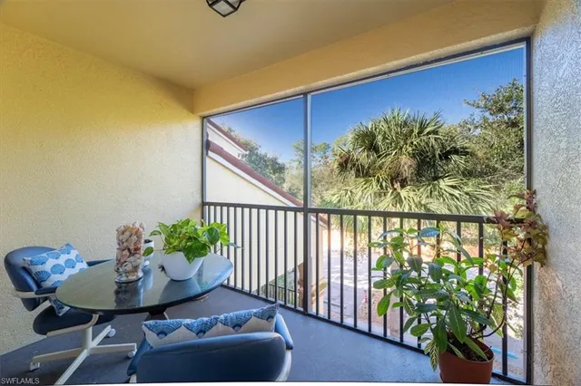 a view of a chairs and table in the balcony