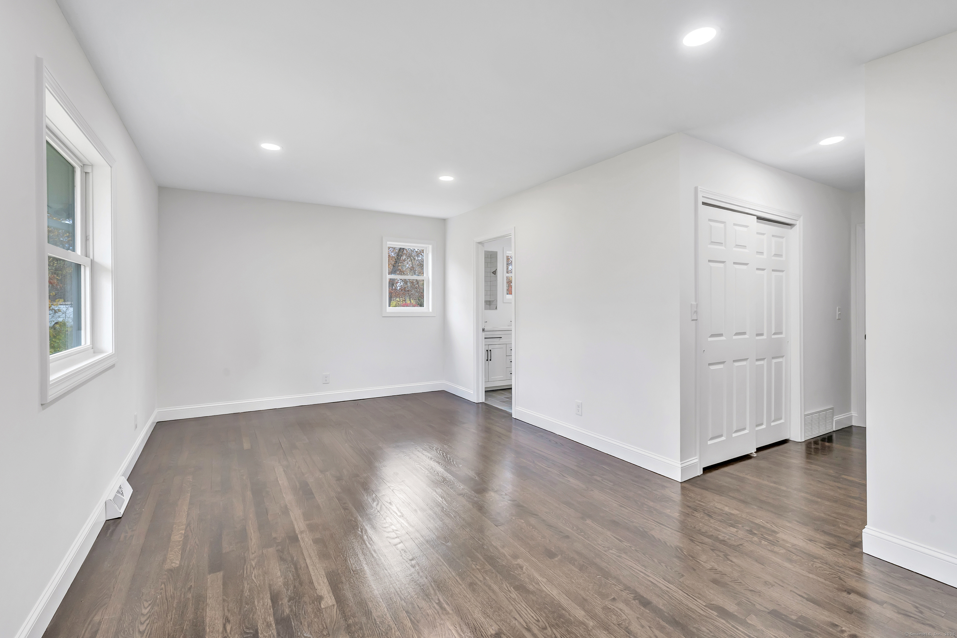 159 Tom Swamp Road Hamden, CT 06518 - Photo 26 of 38 an empty room with wooden floor and windows