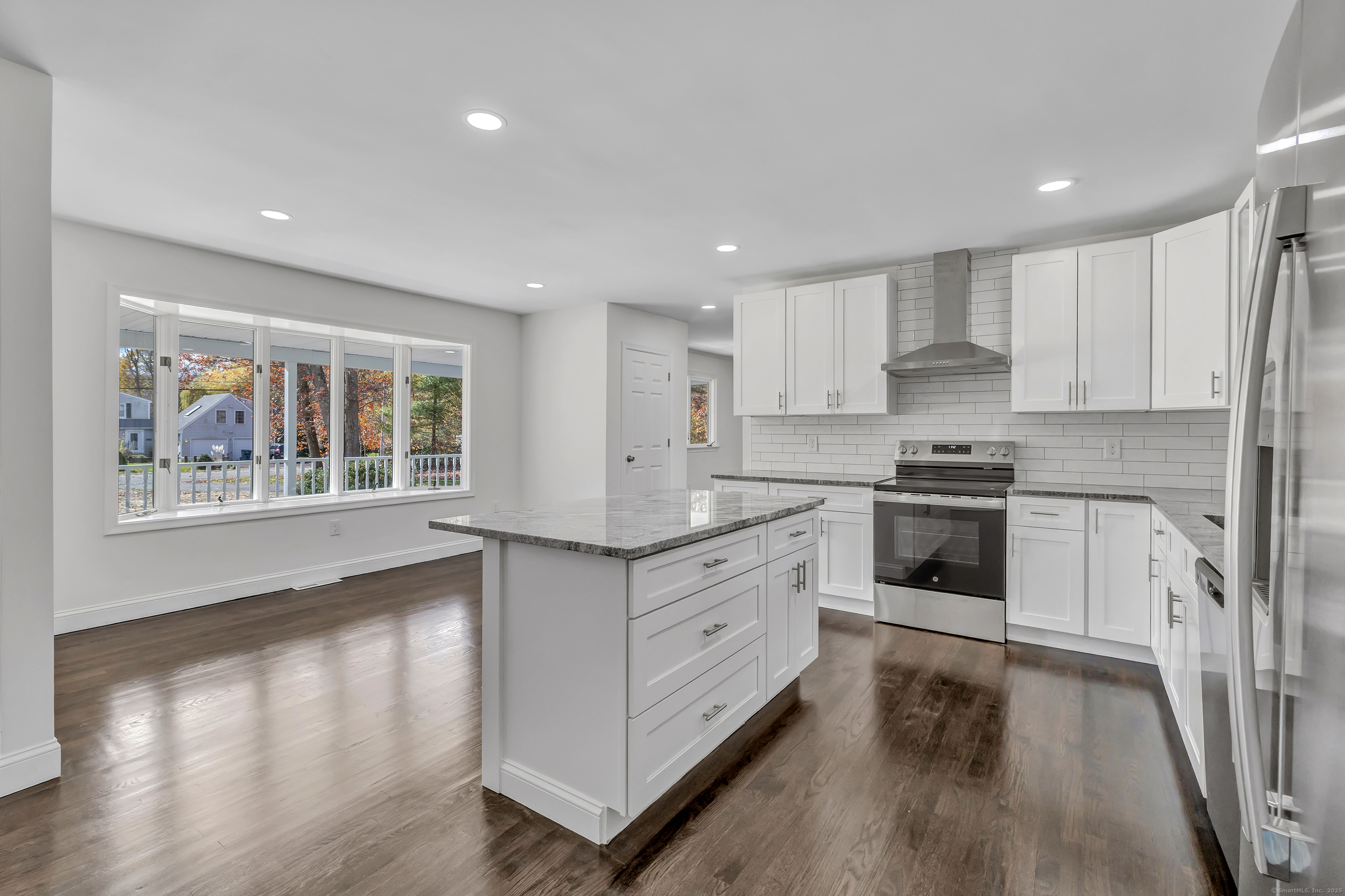 159 Tom Swamp Road Hamden, CT 06518 - Photo 6 of 38 a kitchen with stainless steel appliances granite countertop a stove a sink and a refrigerator with wooden floor
