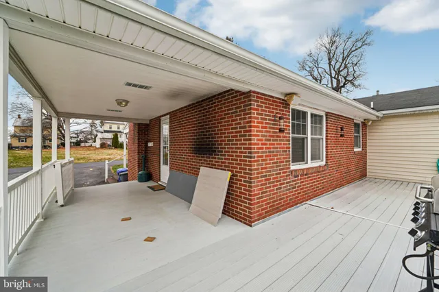 a balcony with furniture and large windows