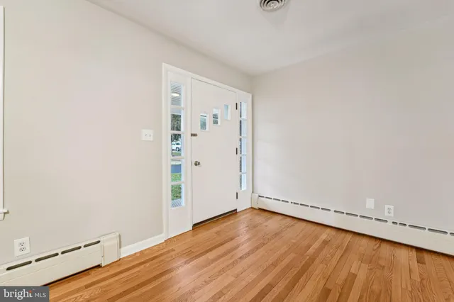 an empty room with wooden floor