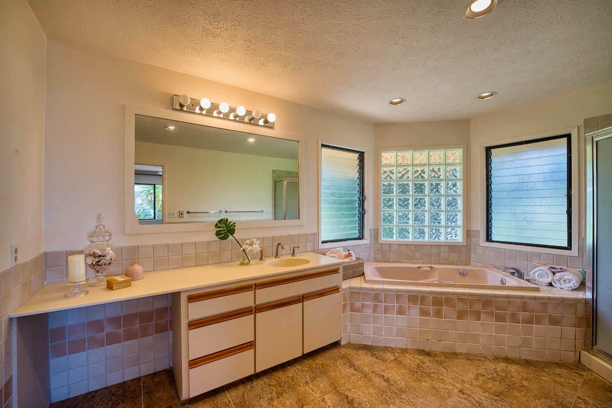 708 Kukuau Street Hilo, HI 96720 - Photo 15 of 18 a bathroom with a tub double vanity sink and mirror