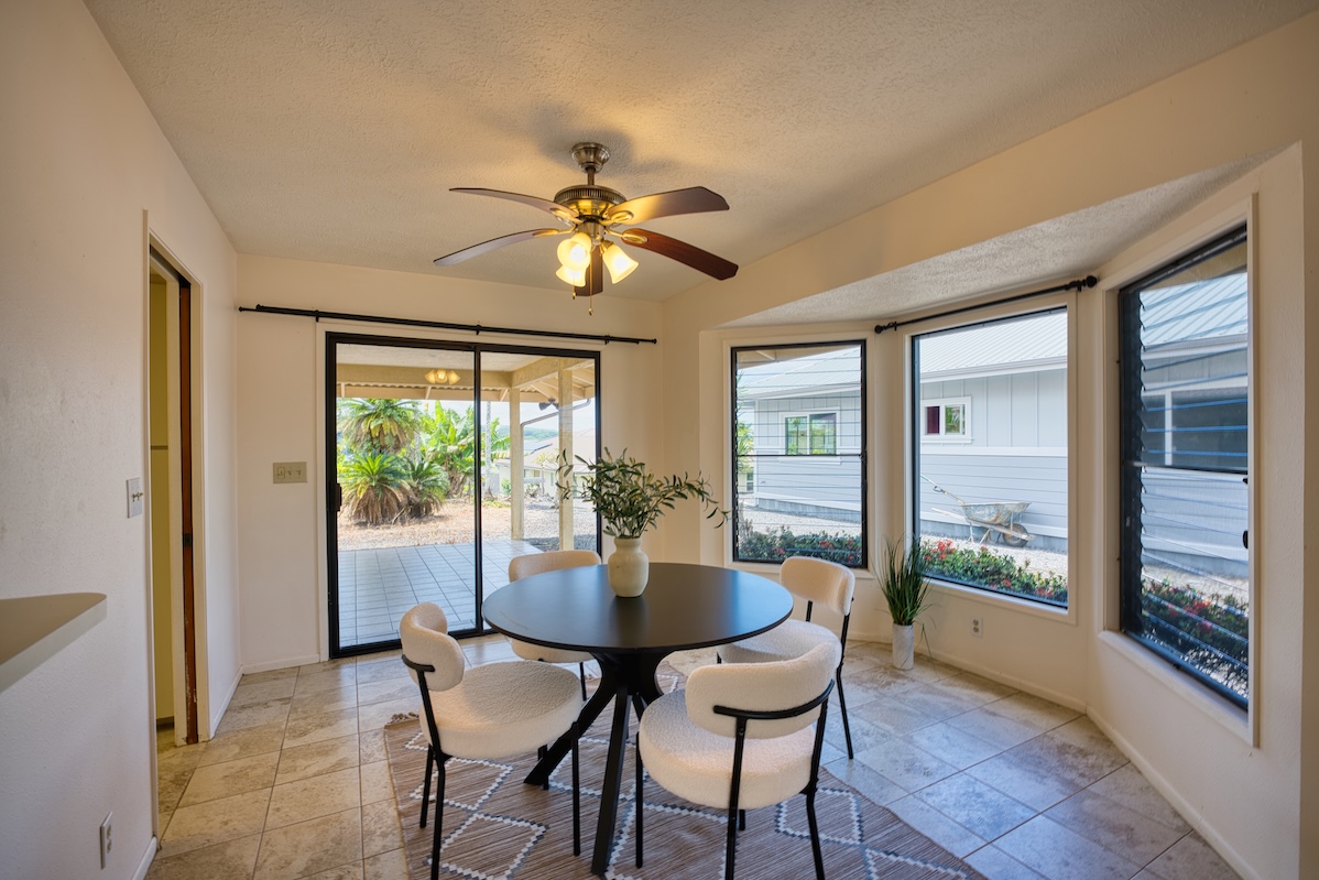 708 Kukuau Street Hilo, HI 96720 - Photo 6 of 18 a dining room with furniture a chandelier and wooden floor