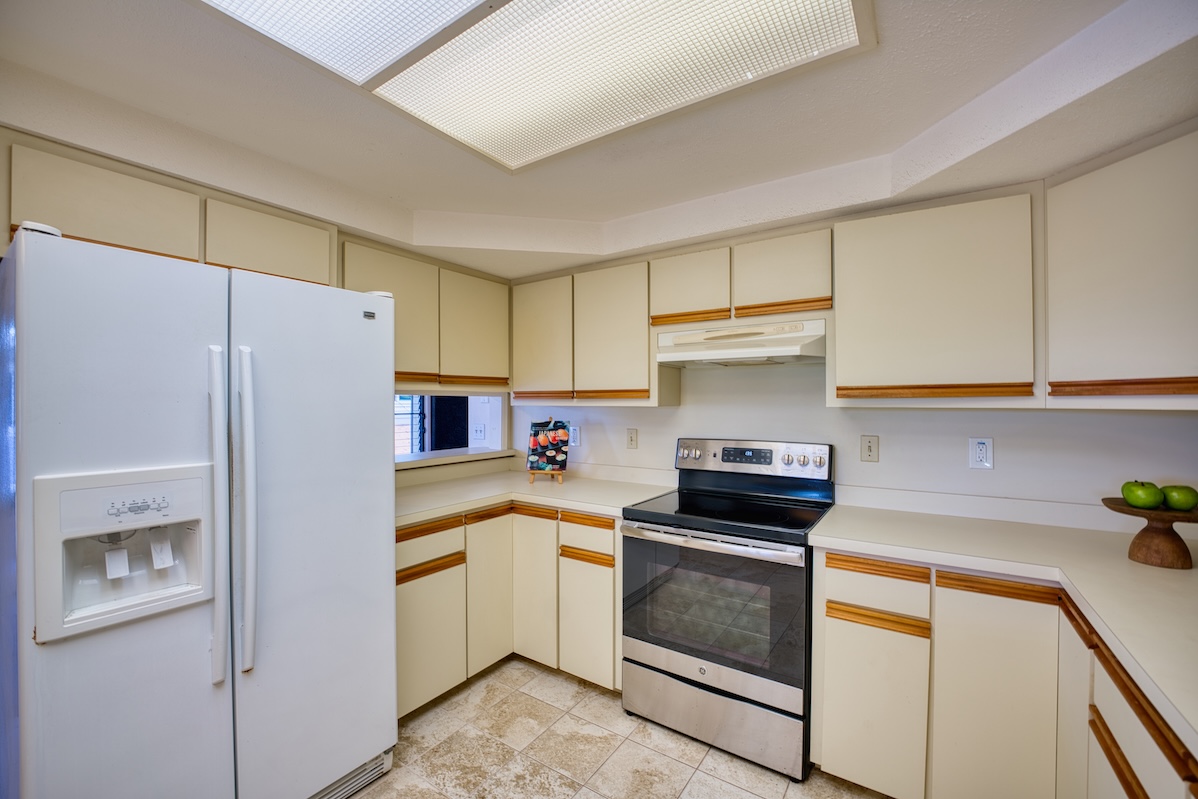708 Kukuau Street Hilo, HI 96720 - Photo 8 of 18 a kitchen with a refrigerator a stove a sink and cabinets