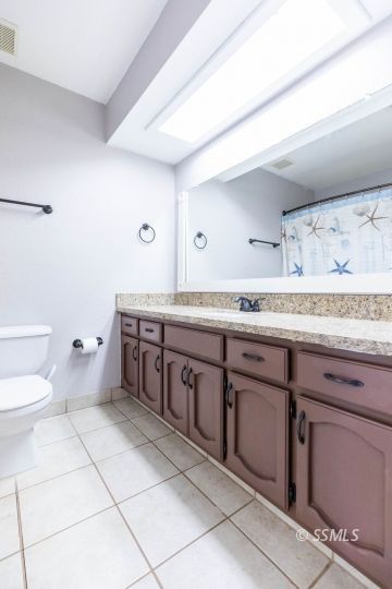 732 South Chesapeake Street Ridgecrest, CA 93555 - Photo 24 of 28 a spacious bathroom with a granite countertop toilet sink and mirror