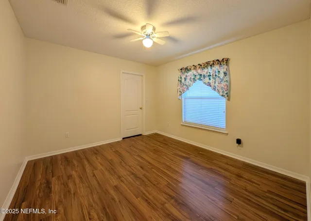 a view of room with window and ceiling fan
