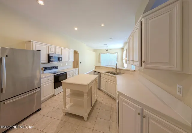 a kitchen with cabinets and stainless steel appliances
