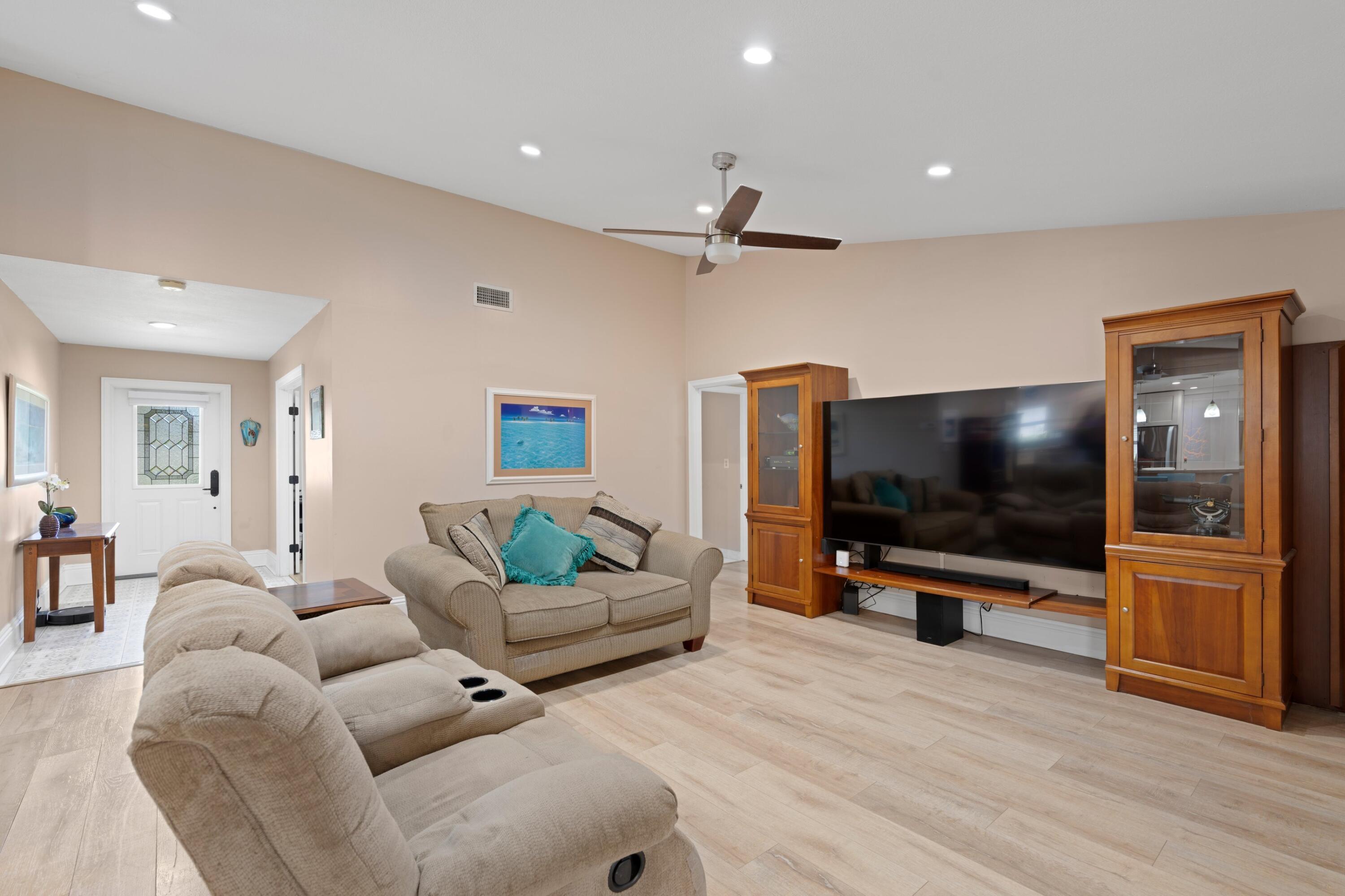 7980 Cloverfield Circle Boca Raton, FL 33433 - Photo 12 of 44 a living room with furniture and a flat screen tv