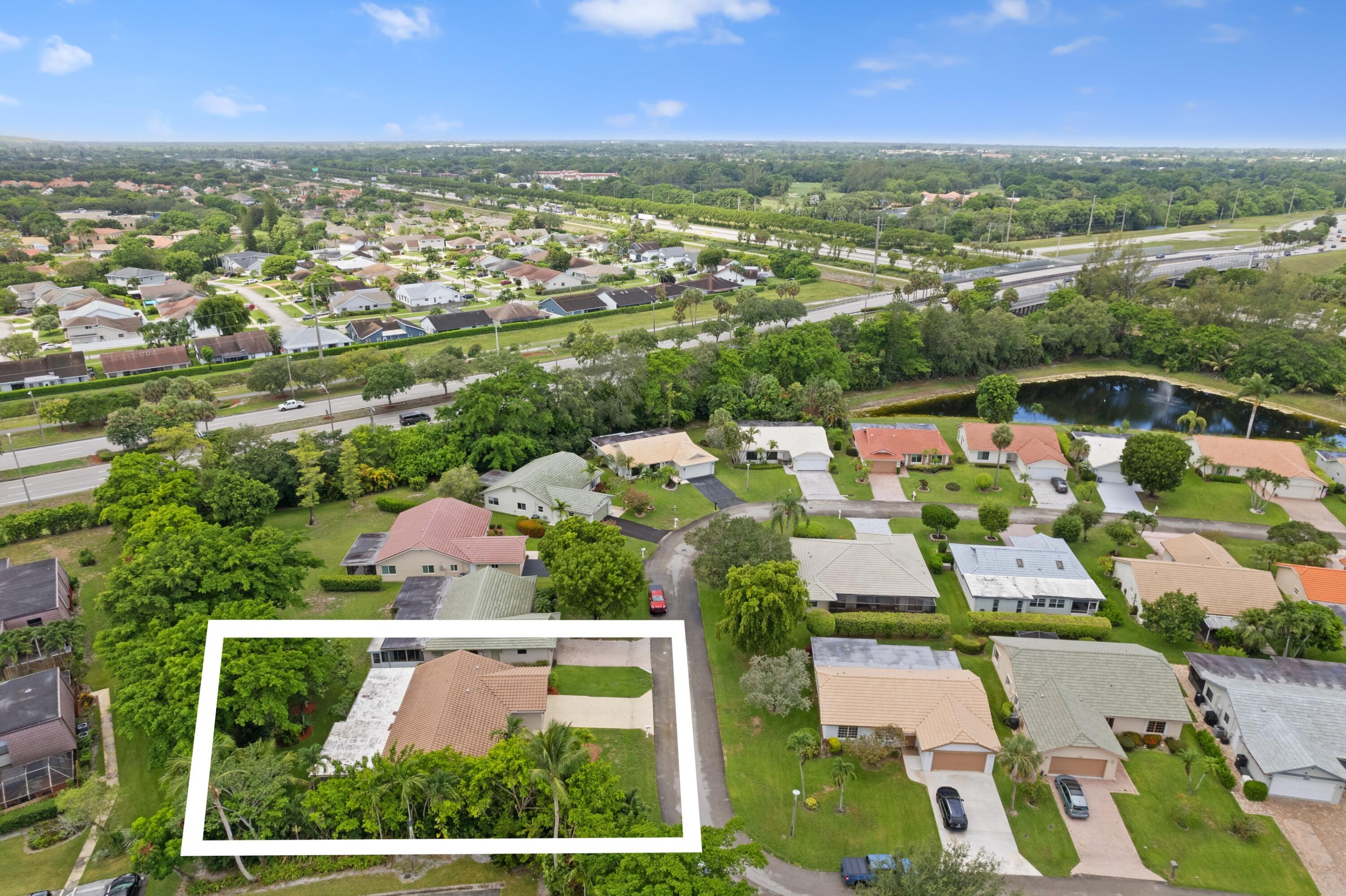 7980 Cloverfield Circle Boca Raton, FL 33433 - Photo 28 of 44 an aerial view of residential houses with outdoor space and river