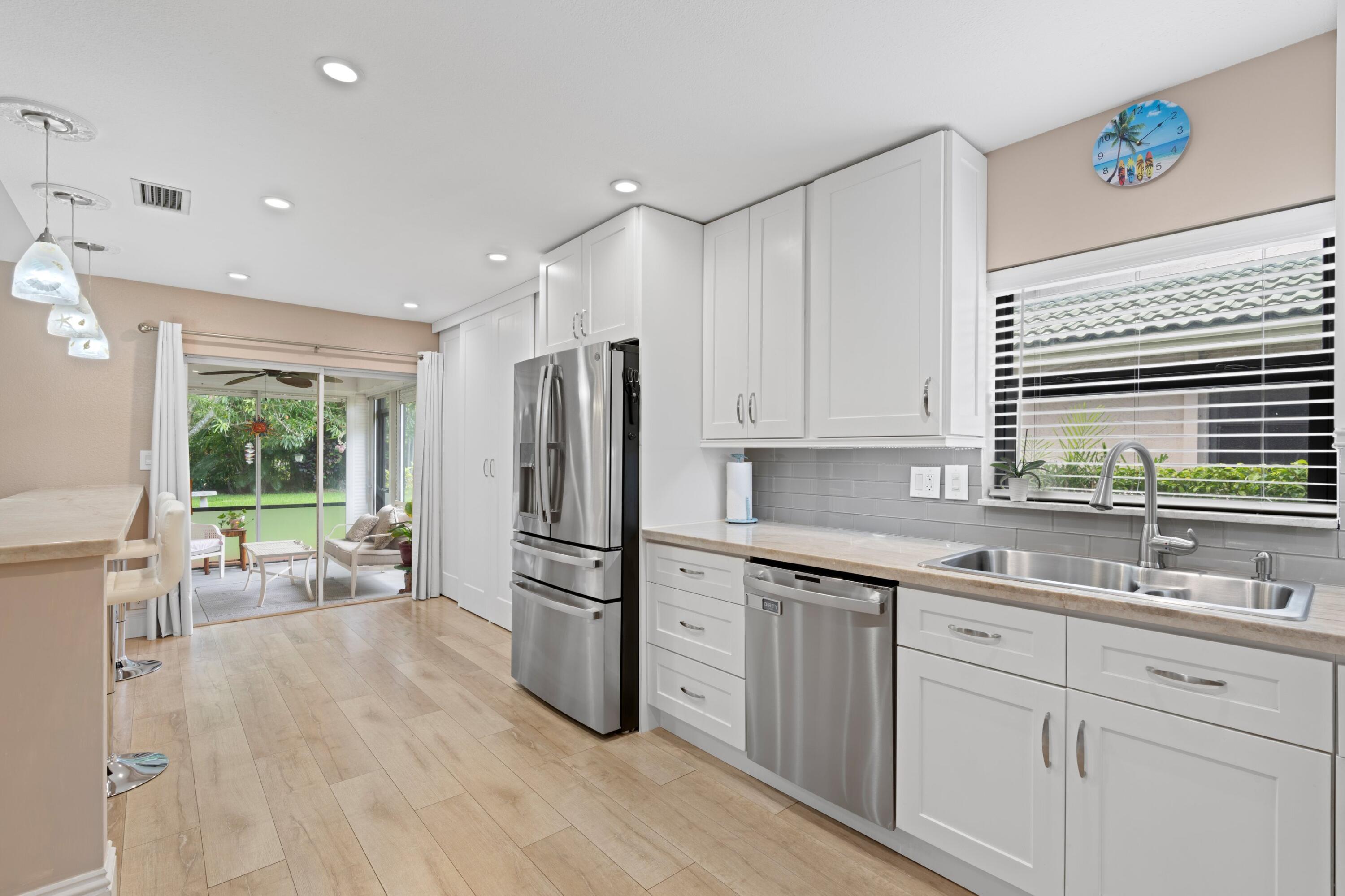 7980 Cloverfield Circle Boca Raton, FL 33433 - Photo 5 of 44 a kitchen with a sink appliances and cabinets