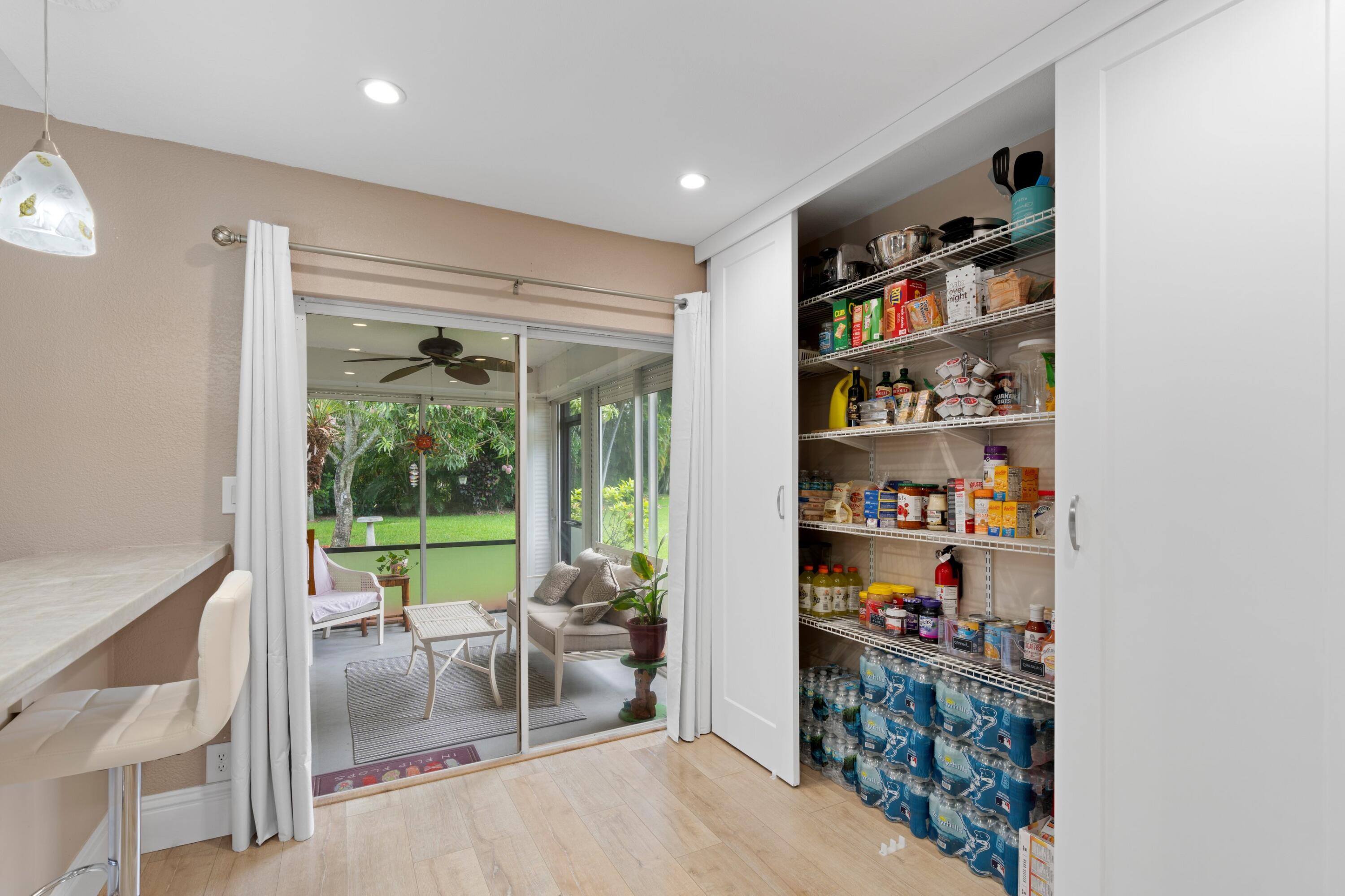 7980 Cloverfield Circle Boca Raton, FL 33433 - Photo 8 of 44 a living room with furniture and a book shelf