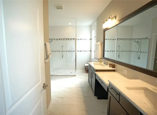 a bathroom with a tub sink and mirror