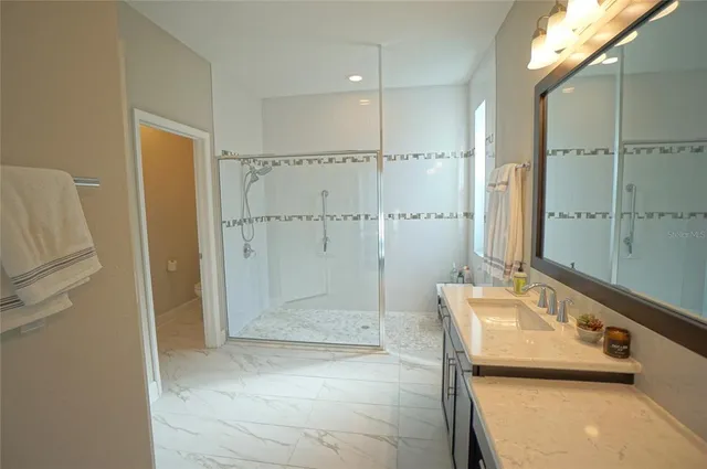 a bathroom with a sink a toilet and shower