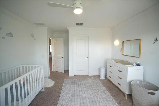 a spacious bedroom with a bed and a dresser