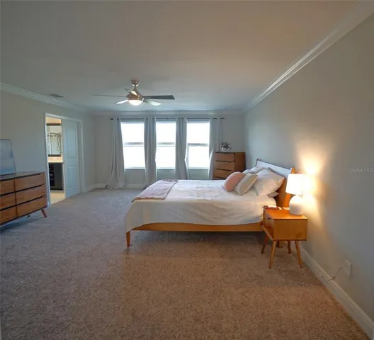 a bedroom with a bed and a chair