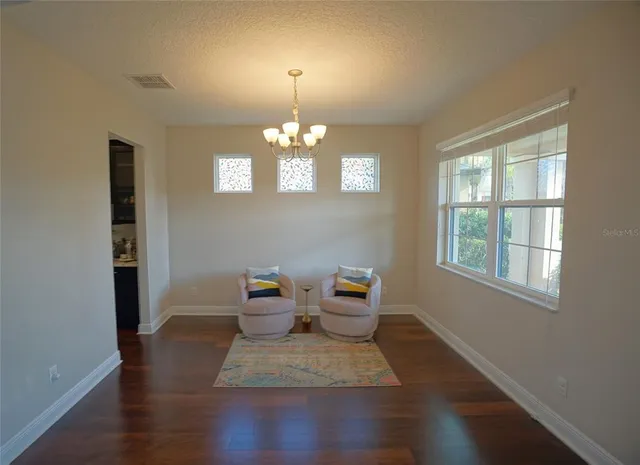 a view of a livingroom with wooden floor and a window