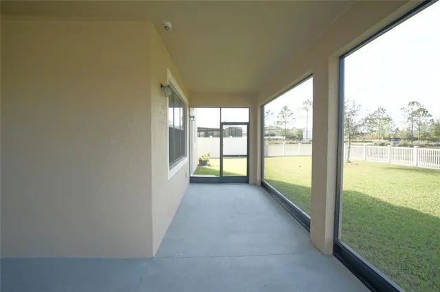 a view of a hallway with wooden floor and stairs