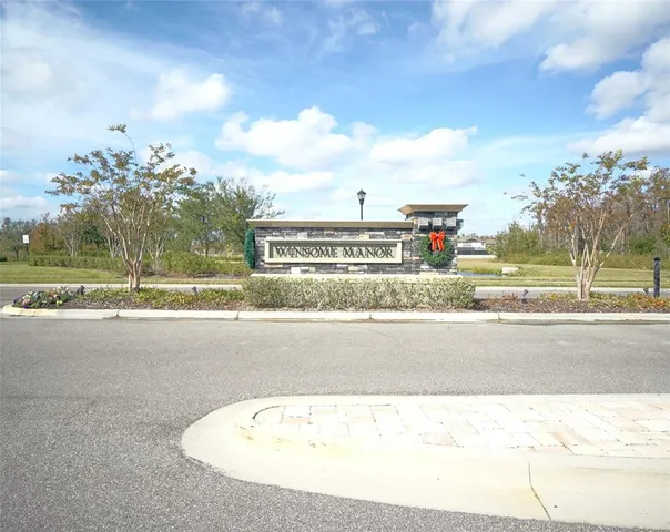a view of a road with a wrought fence