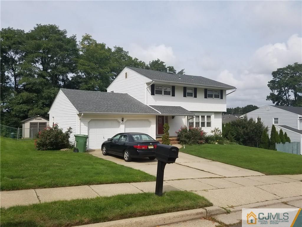7 Stradford Road Sayreville, NJ 08859 - Photo 2 of 25 a front view of a house with a garden and yard