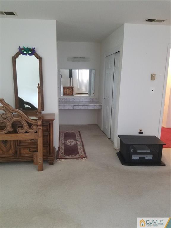 7 Stradford Road Sayreville, NJ 08859 - Photo 18 of 25 a room with furniture and a mirror