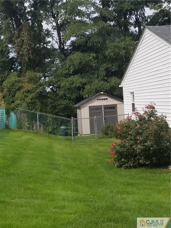 7 Stradford Road Sayreville, NJ 08859 - Photo 20 of 25 a backyard of a house with plants and large trees