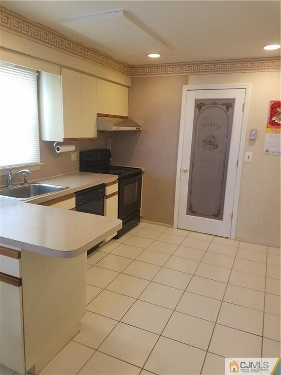 7 Stradford Road Sayreville, NJ 08859 - Photo 3 of 25 a kitchen with stainless steel appliances granite countertop a sink and a stove