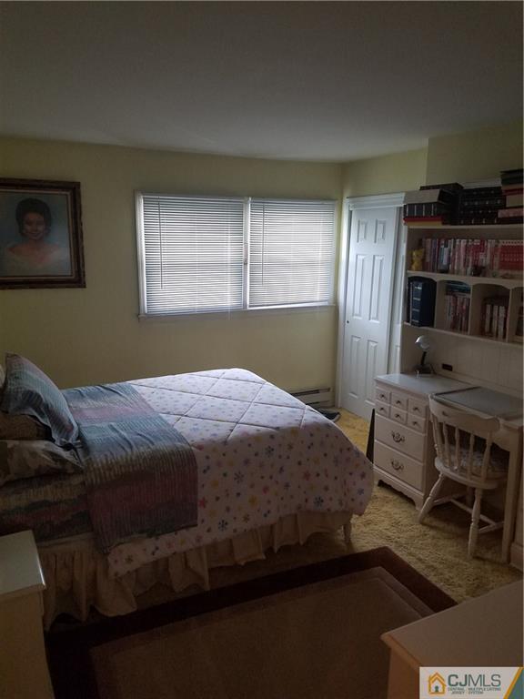 7 Stradford Road Sayreville, NJ 08859 - Photo 22 of 25 a bedroom with a bed wooden floor and window