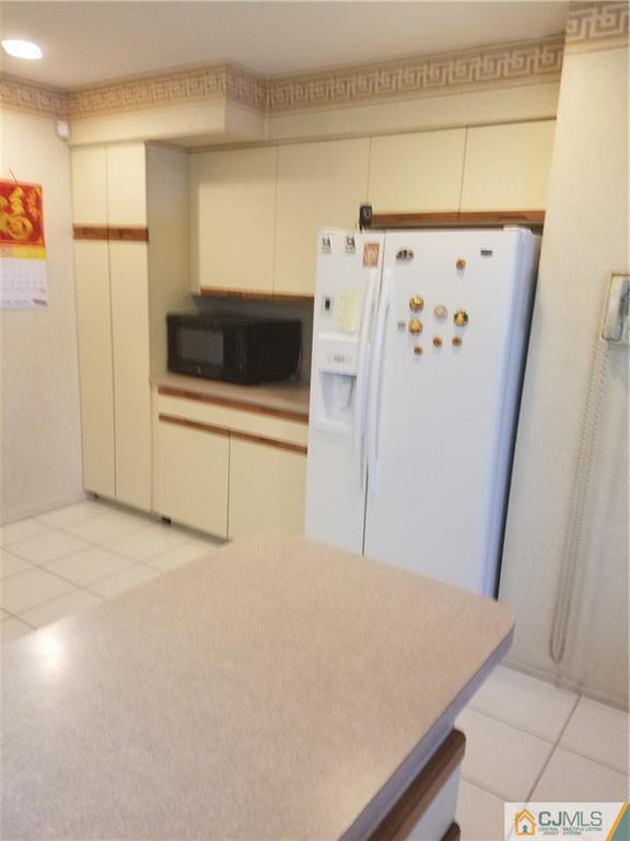 7 Stradford Road Sayreville, NJ 08859 - Photo 6 of 25 a view of a kitchen with refrigerator and white cabinets