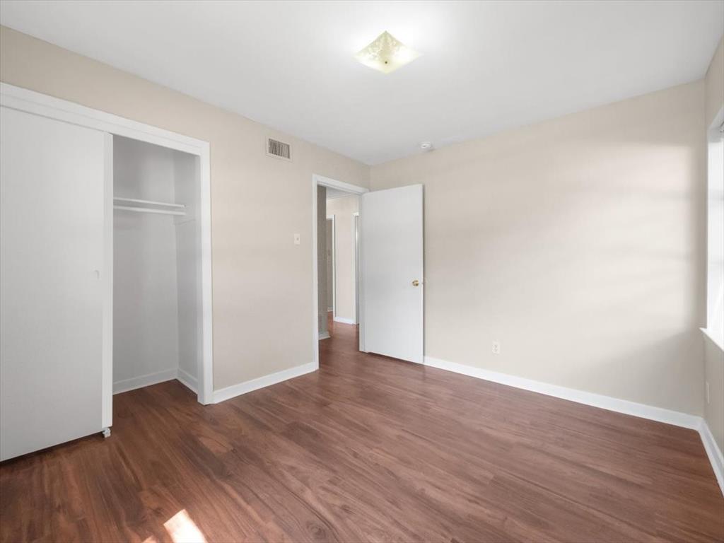 403 Rolando Drive Garland, TX 75040 - Photo 11 of 25 a view of an empty room with wooden floor
