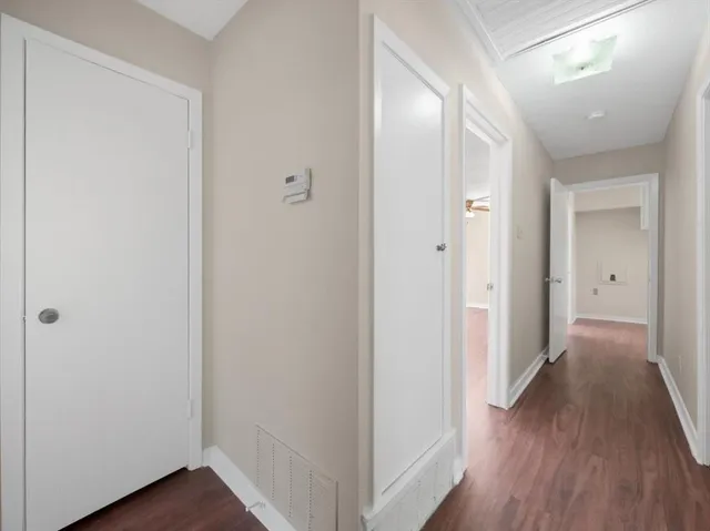 a view of hallway with wooden floor