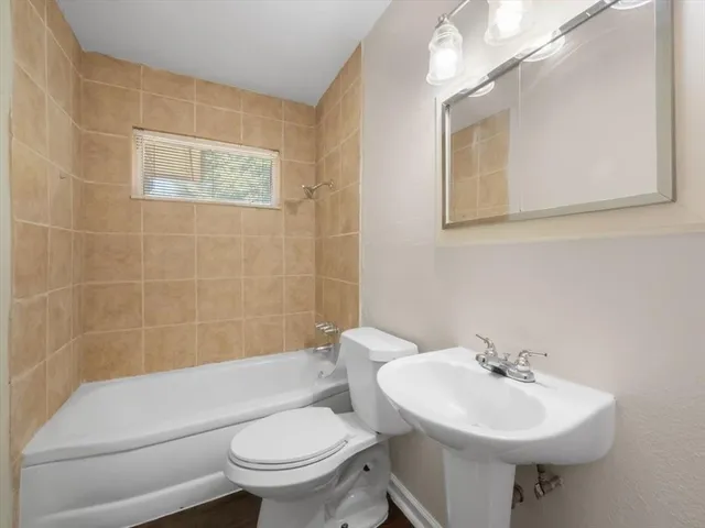 a bathroom with a sink toilet and a mirror