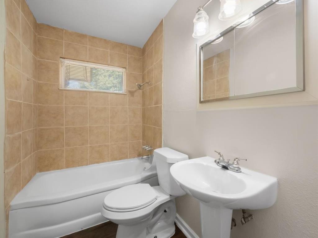 403 Rolando Drive Garland, TX 75040 - Photo 16 of 25 a bathroom with a sink toilet and a mirror