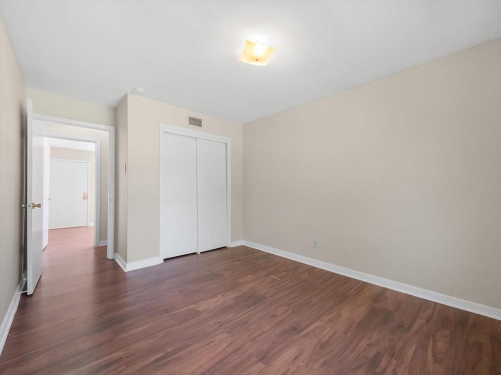 403 Rolando Drive Garland, TX 75040 - Photo 17 of 25 a view of an empty room with wooden floor
