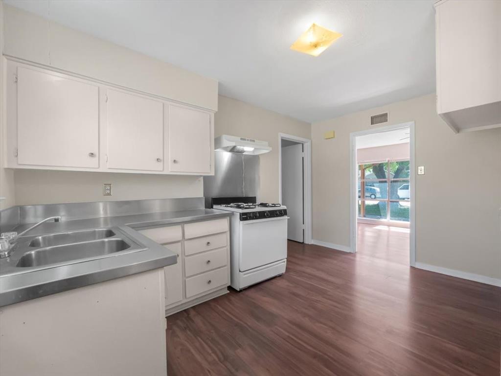 403 Rolando Drive Garland, TX 75040 - Photo 19 of 25 a kitchen with a sink cabinets and wooden floor