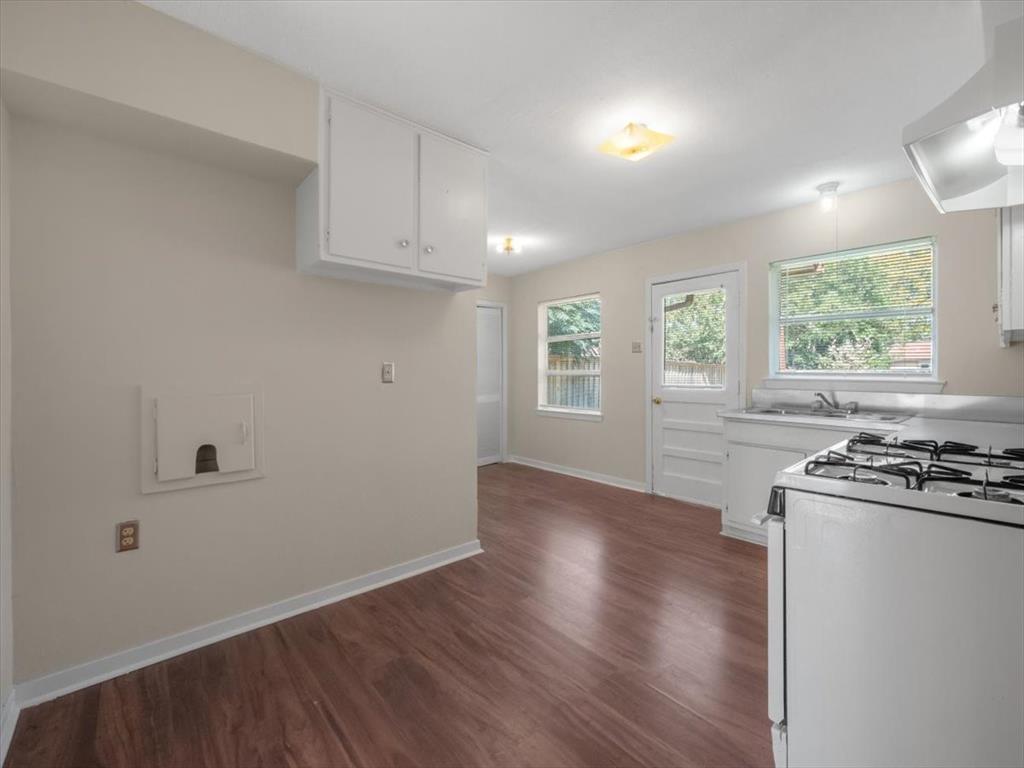 403 Rolando Drive Garland, TX 75040 - Photo 21 of 25 an empty room with wooden floor and windows