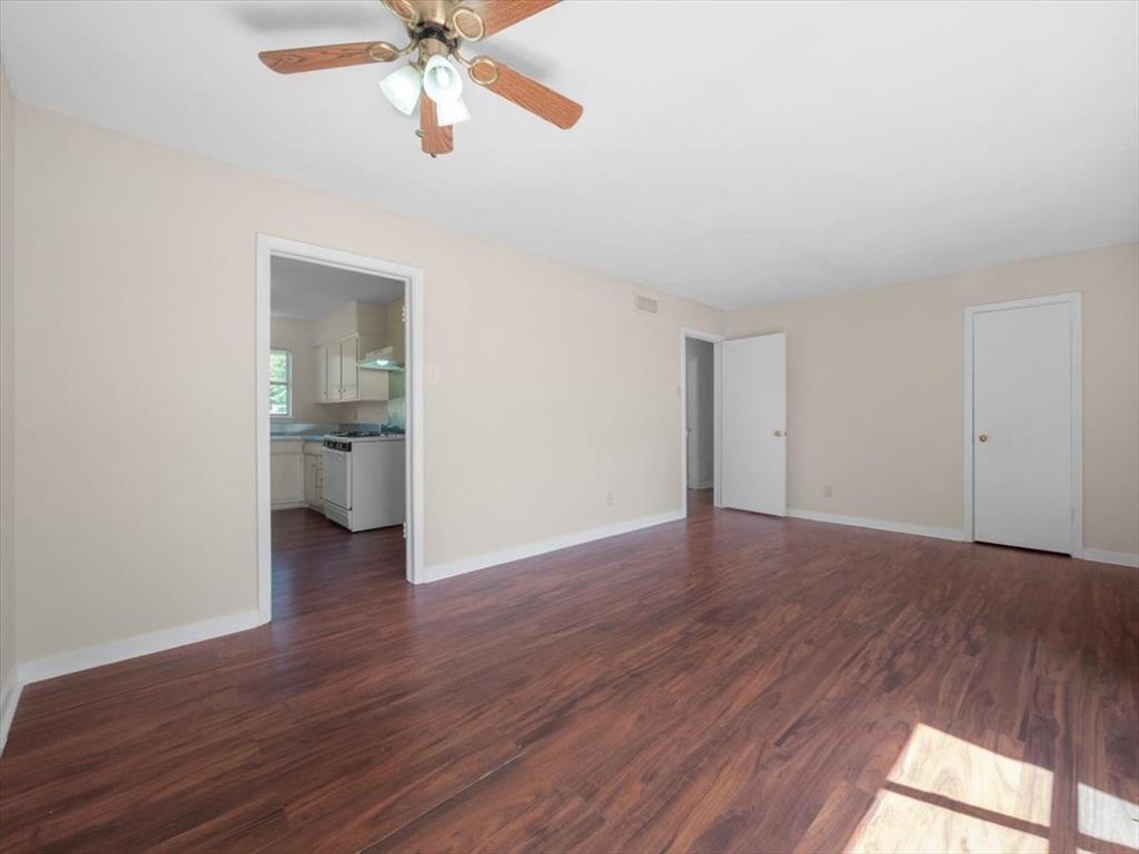 403 Rolando Drive Garland, TX 75040 - Photo 23 of 25 a view of a room with wooden floor and a ceiling fan