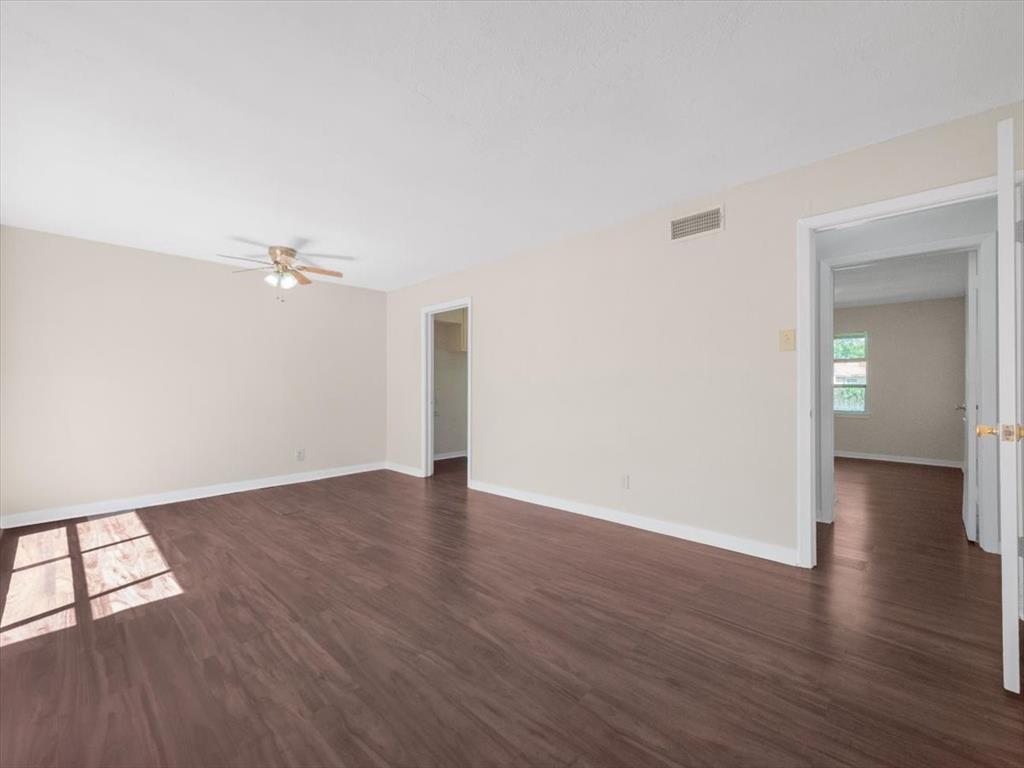 403 Rolando Drive Garland, TX 75040 - Photo 24 of 25 an empty room with wooden floor and windows