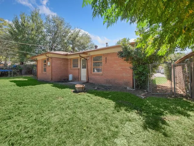 a view of backyard of house with green space