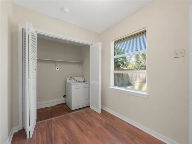 a view of a room that has a bed and a window