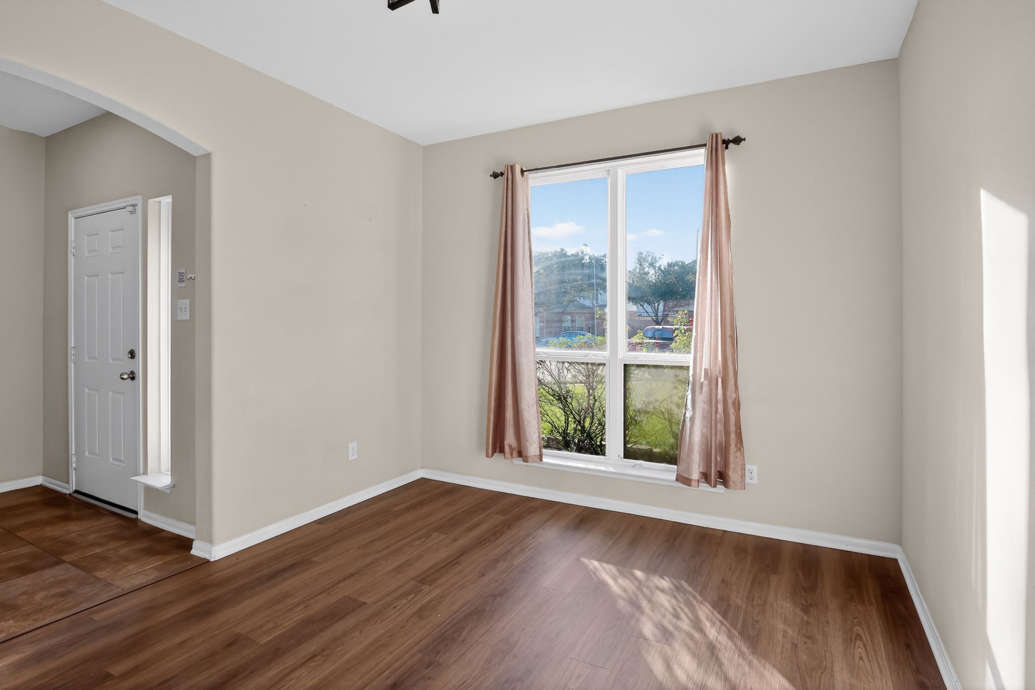 4938 Yearling Ridge Court Katy, TX 77449 - Photo 9 of 29 an empty room with wooden floor and windows