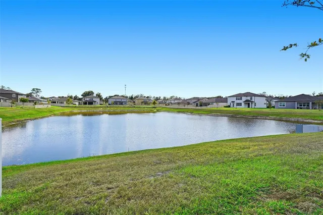 a view of a lake with houses in the back