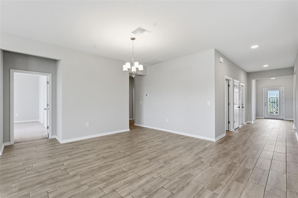 17618 Cortes Creek Boulevard Spring Hill, FL 34610 - Photo 18 of 40 wooden floor in an empty room with a window