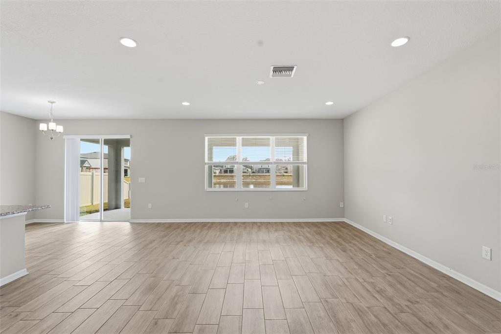 17618 Cortes Creek Boulevard Spring Hill, FL 34610 - Photo 20 of 40 wooden floor in an empty room with a window